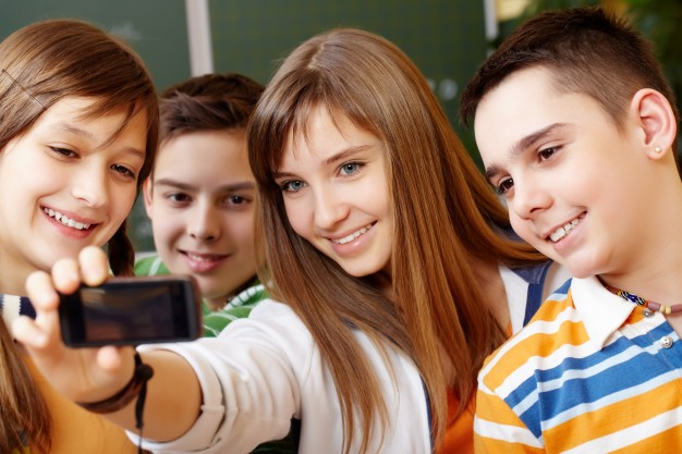 happy-students-taking-selfie-in-class_1098-1213